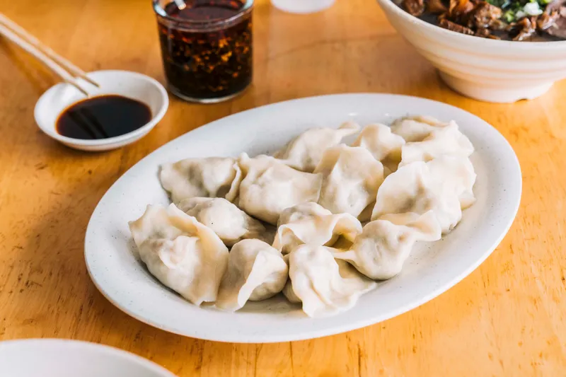 Steamed dumplings with dipping sauce at Yuanbao Jiaozi